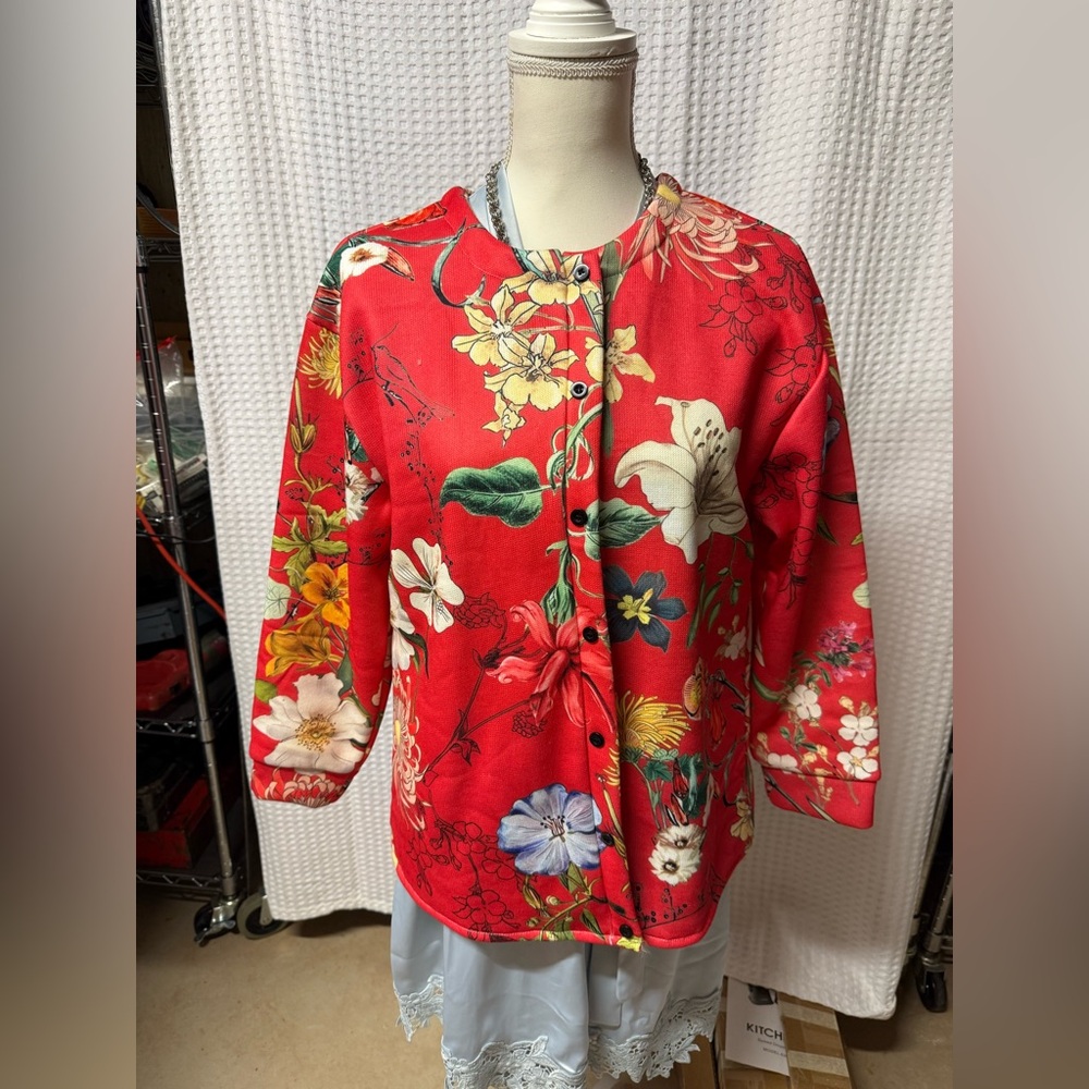 Floral Red Women's Top.  Ordered on line but did not fit.  Fabric is smooth.